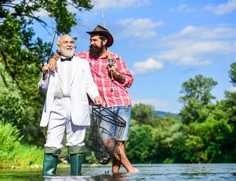 Premium Photo Gone Fishing Fly Fishing Adventures Retired Father And Mature Son With Beard