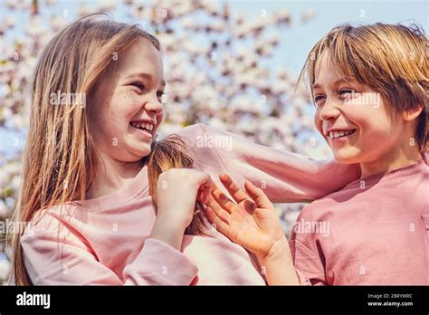 Smiling Brunette Boy And Girl Standing Outdoors Teasing Each Other Stock Photo Alamy