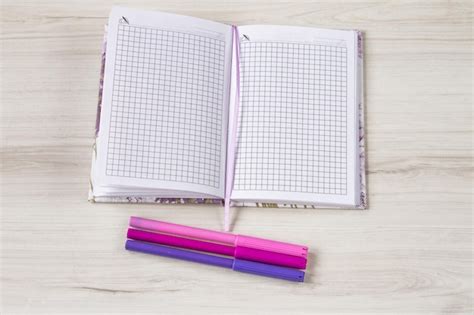 Premium Photo Notebook With Colorful Marker On Wooden Table