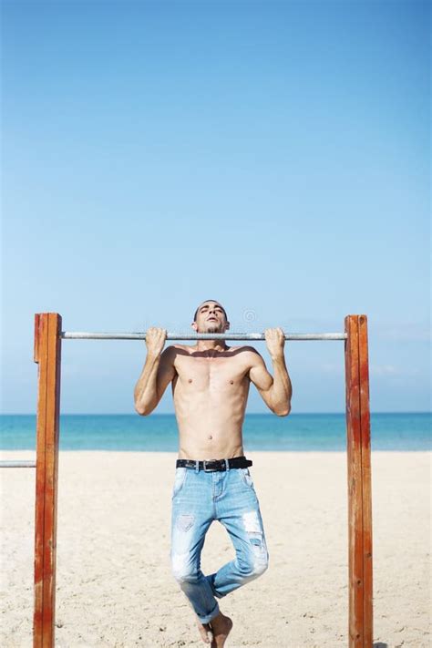 A Male Athlete With A Naked Torso Is Training On A Horizontal Bar Stock Image Image Of People
