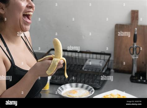 Beautiful Latina Woman With A Banana In Her Hand Laughing Out Loud Girl Eating A Banana In Her