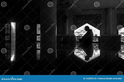Prayer Time A Man Looks Solemnly During Prayer In Black And White
