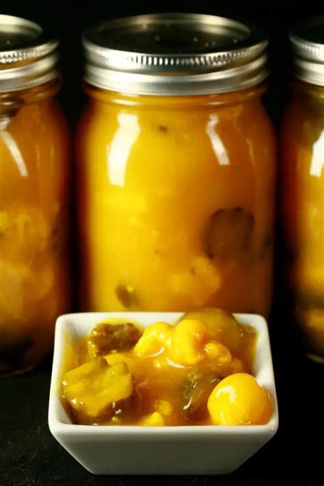 Several Jars Filled With Food Sitting On Top Of A Black Table Next To