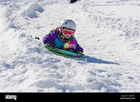 Sledding fun in winter-wonderland Stock Photo - Alamy