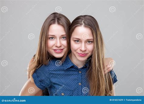 Studio Portait Of Young Twin Sisters Embracing Stock Image Image Of