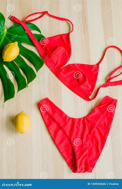 Bright Trendy Bikini On A Wooden Background With Yellow Lemons