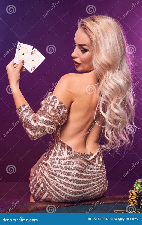 Blonde Woman With A Perfect Hairstyle And Bright Make Up Is Posing With Playing Cards In Her
