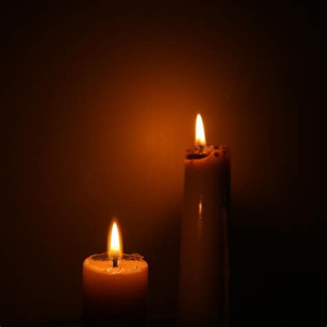 Premium Photo Close Up Of Lit Candle Against Black Background