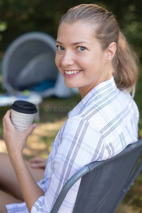 Beautiful Blonde Woman Sitting By Tent Holding Drink Stock Photo Image Of Relaxed Beautiful