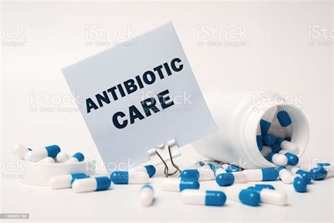 Antibiotic Care Inscription On Paper Note Near Bluewhite Pills Spilling