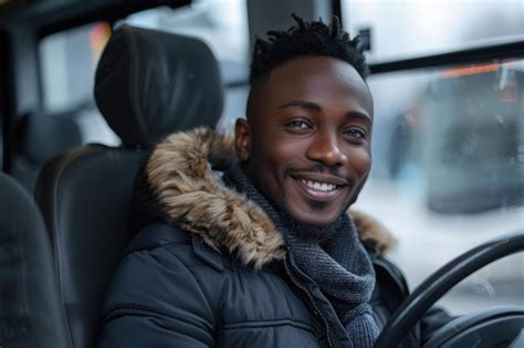 A Male Bus Driver Sitting In The Driver Seat Smiling Behind The Wheel