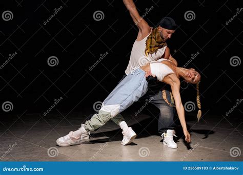 Modern. Fashionable Couple Dancing Hip-hop in Stylish Clothes on Black ...