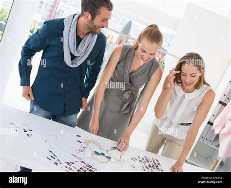 Three Fashion Designers Discussing Designs Stock Photo Alamy