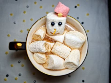 Top View Of Hot Chocolate With Snowman Marshmallows In A Cup With A Snowflake Stock Photo