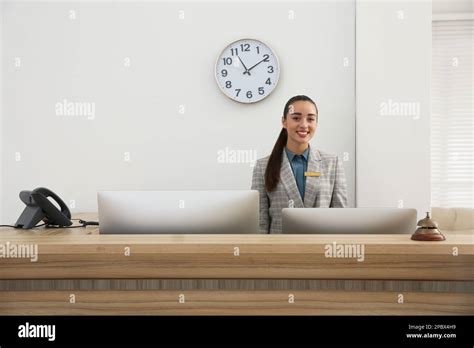 Portrait Of Beautiful Receptionist At Counter In Hotel Stock Photo Alamy