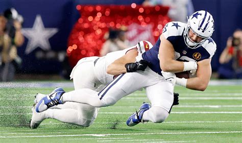 Download Football Tackle Action Shot Wallpaper