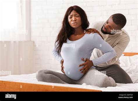 Pregnant Lady Suffering From Backache Husband Massaging Her Shoulders