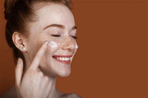 Premium Photo Close Up Photo Of A Ginger Woman With Freckles And Naked Shoulders Applying A