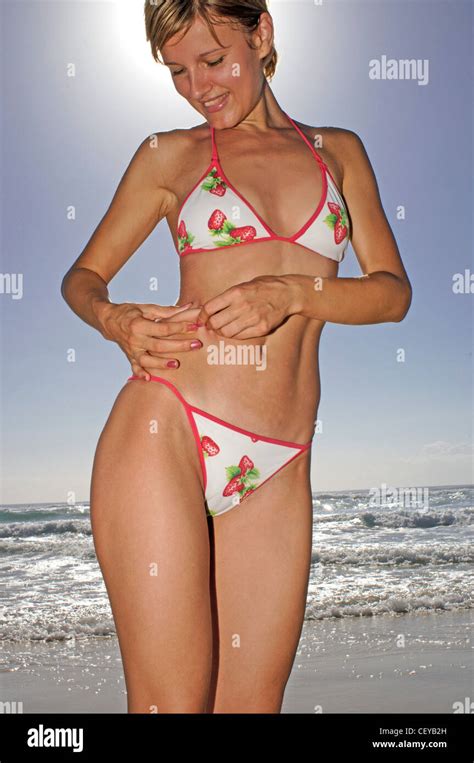 Female Short Blonde Hair White Bikini With Red Edging And Strawberry Pattern Standing On