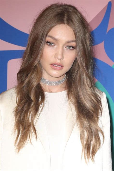 Gigi Hadid S Hairstyles Hair Colors Steal Her Style Dark Blonde Hair Tan Skin Blonde Hair