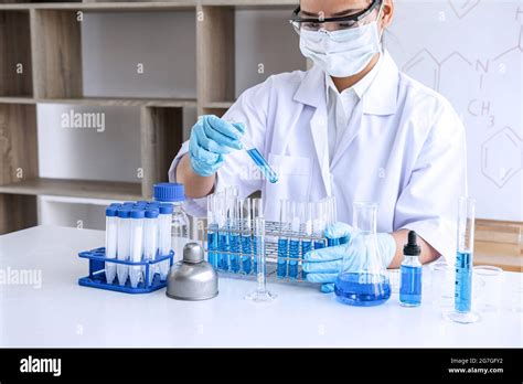 Biochemistry laboratory research, Chemist is analyzing sample in ...