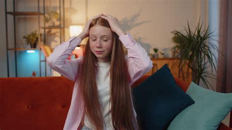 Furious young redhead child girl screams from stress tension problems