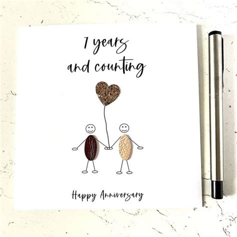 An Anniversary Card With Two People Holding A Heart Shaped Balloon And