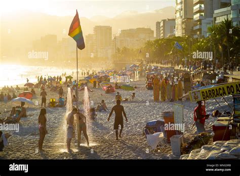 RIO DE JANEIRO FEBRUARY Beachgoers Shower Under A Gay Pride Rainbow Flag As The Sun
