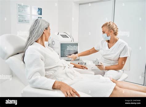 Attentive Blonde Specialist Pointing At Screen Of Computer Stock Photo Alamy