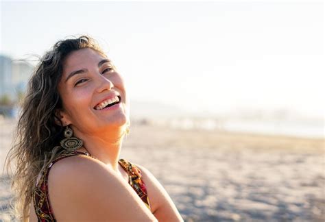 Joven Latina Sentada En La Playa Sonriendo Feliz Retrato Foto Premium