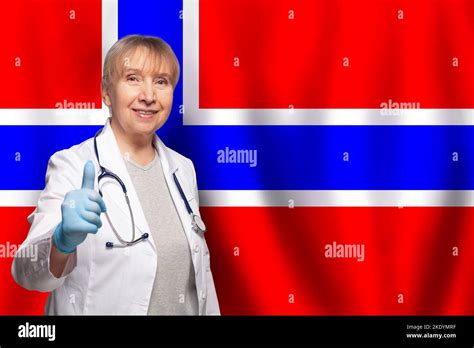 Norwegian Smiling Mature Doctor Woman Holding Stethoscope On Flag Of Norway Background Stock