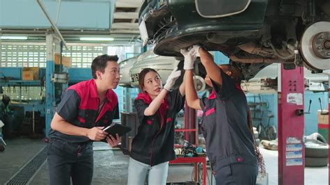 Professional automotive supervisors' teams inspect repair work with