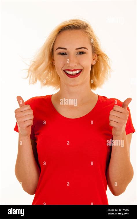 Attractive Blonde Woman Shows Thumb Up As A Gesture For Success Isolated Over White Background