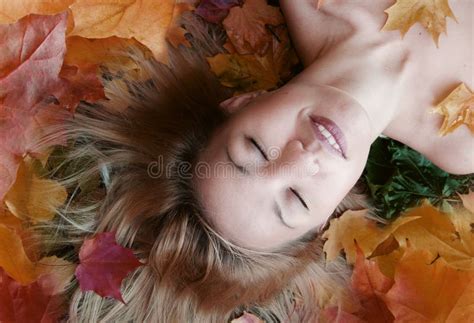 A Redhead Woman Laying Naked On Fallen Leaves Stock Photo Image Of November Leaf 21107300
