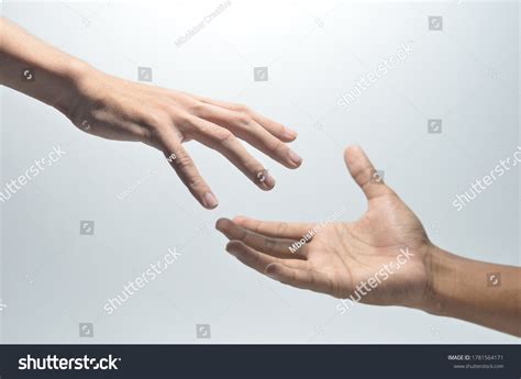 Two Hands Reaching Out To Each Other