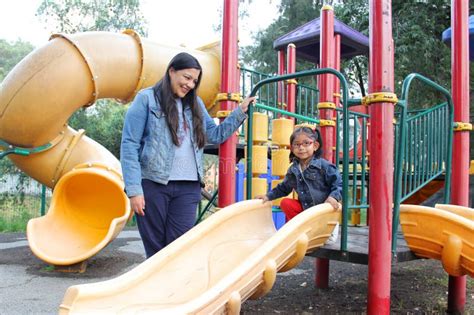 Divorced Single Mom And Brunette Latina Year Old Daughter Play In The Park Games In Poverty