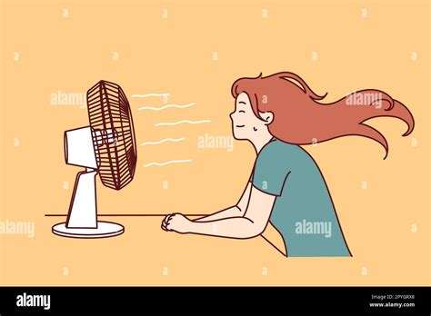 Woman Sitting In Front Of Fan Enjoying Cold Wind After Walking In Hot