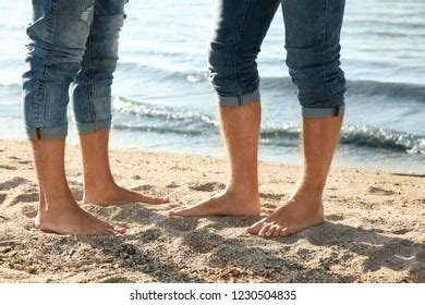 Gay Couple Standing Barefoot On Beach Shutterstock