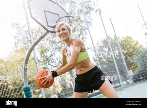 Blonde Woman Playing Basketball Stock Photo Alamy