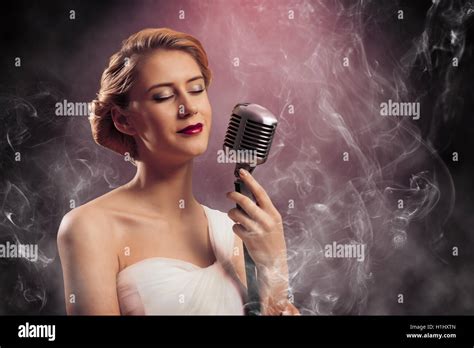 Beautiful Blonde Woman Singer With A Microphone Stock Photo Alamy
