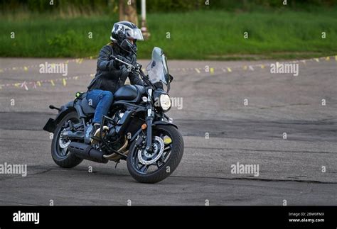 Bikers Driving A Motorcycle Rides Along The Asphalt Road Stock Photo