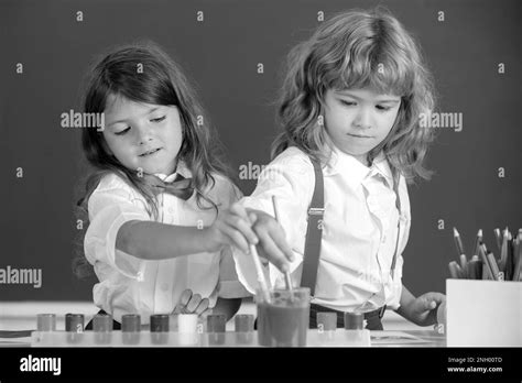 Funny pupils draws in classroom on school blackboard background. School