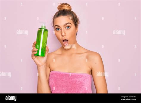 Beautiful Blonde Woman With Blue Eyes Wearing Towel Shower After Bath Holding Aloe Vera Gel