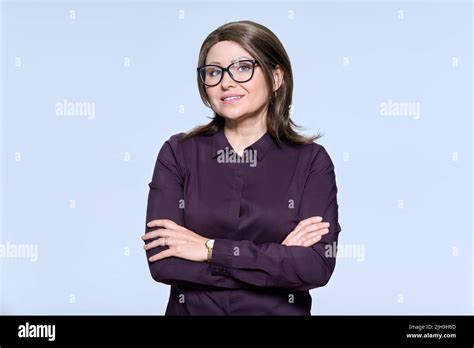 Portrait Of Confident Mature Woman In Glasses Looking At Camera On
