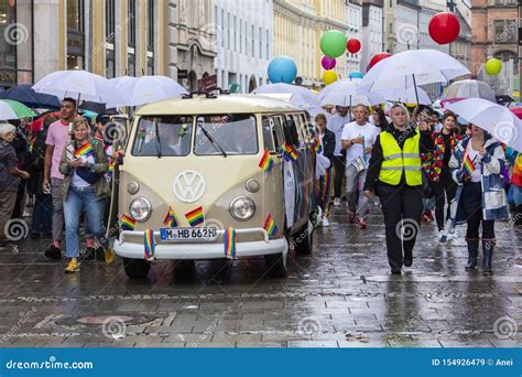 Rainbow Colored VW Bus And People Attending The Gay Pride Parade Also