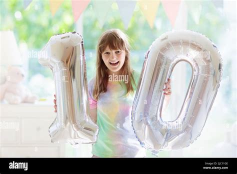 Kids birthday party. Child blowing out candles on colorful cake. Little ...