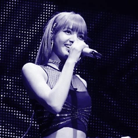 A Woman In A Black And White Photo Holding A Microphone Up To Her Ear While Standing On Stage