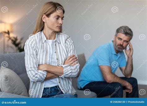 Offended Mature Caucasian Husband Ignoring Wife After Quarrel And Thinking About Divorce On Sofa