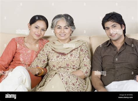 Portrait Of A Mature Woman With Her Son And Daughter In Law Smiling Stock Photo Alamy