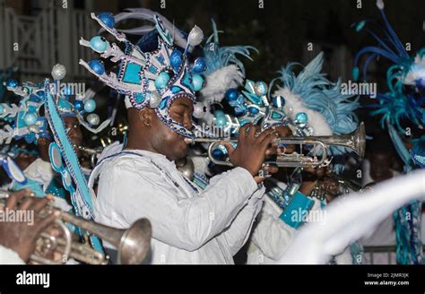 Men Beating Drums And Blowing Trumpets In Colorful Costumes For